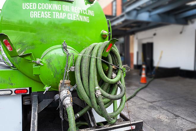 heavy-duty vacuum truck pumping out a grease trap in Amelia