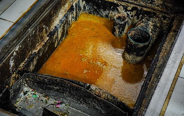 putting off grease trap cleaning can cause clogs, foul odors, and even sewage backups